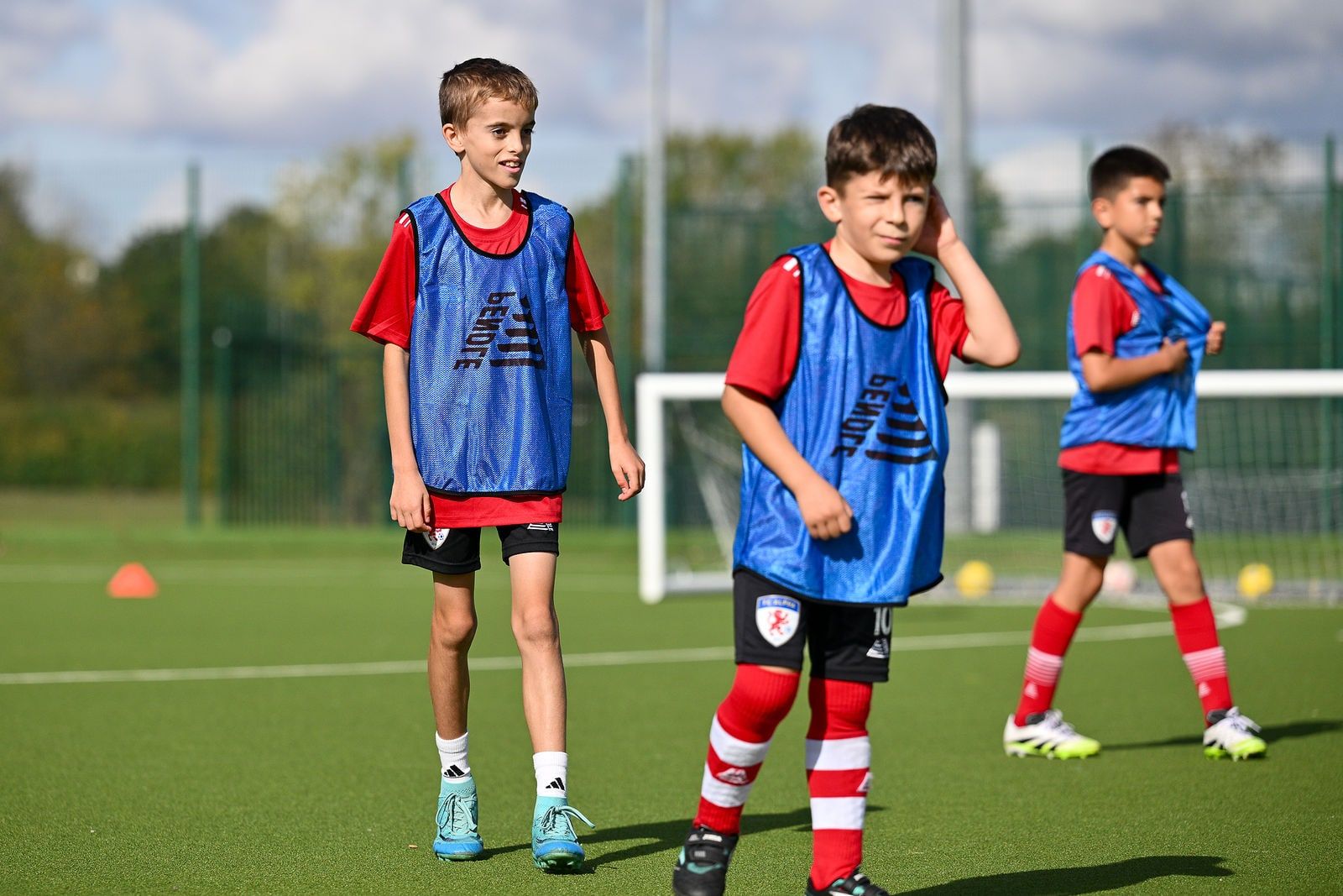 Older academy players in bibs ready for a drill