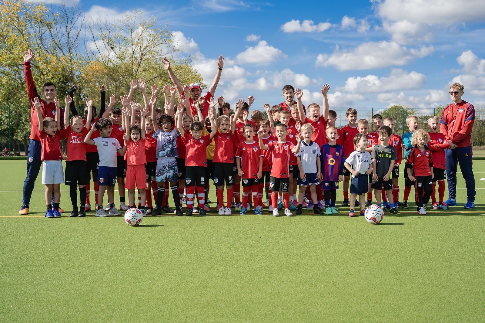 The whole FC Alpha academy with its coaches on the pitch at Basildon Sporting Village