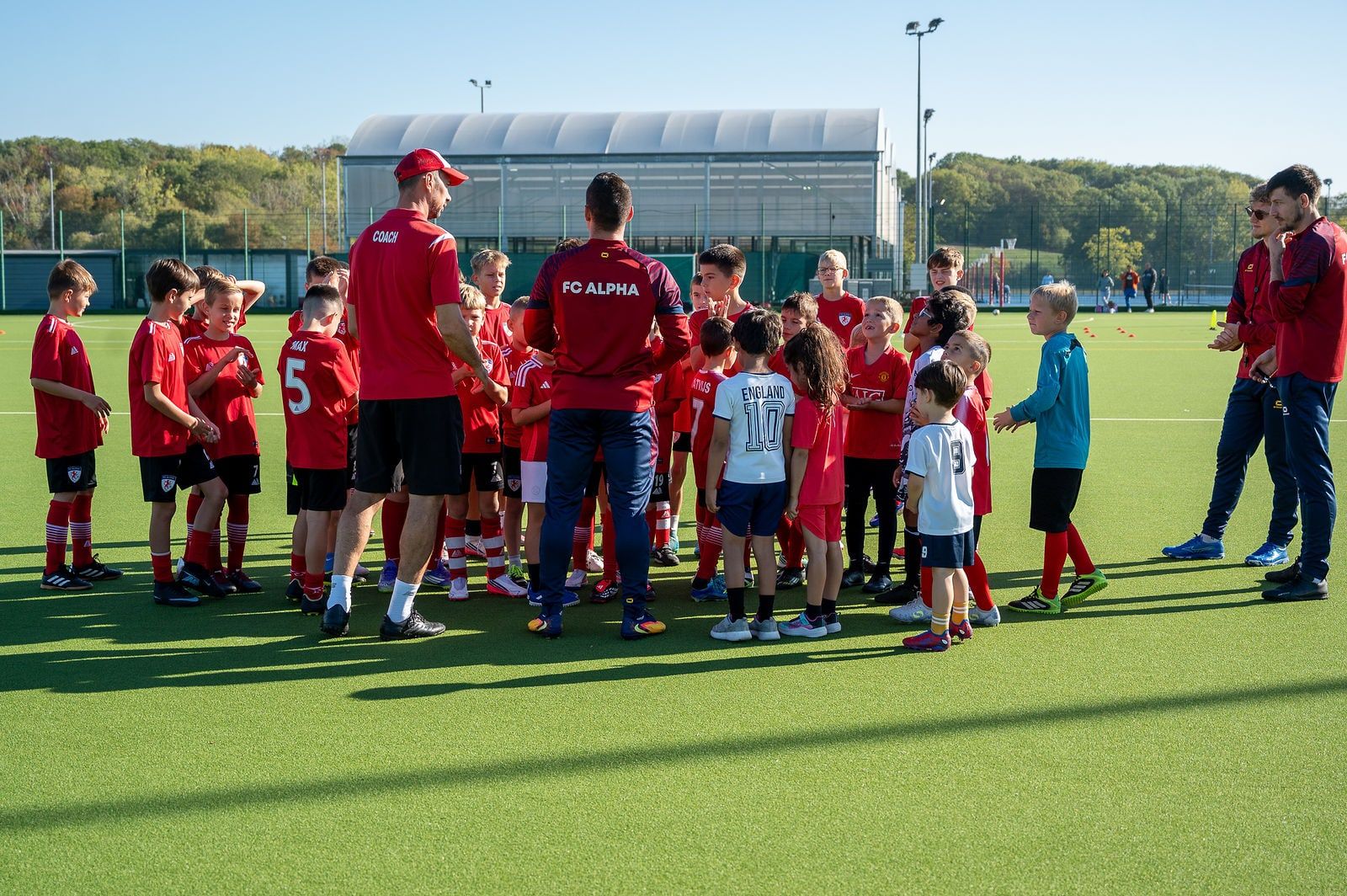 FC Alpha coaches talking to the whole academy before a session