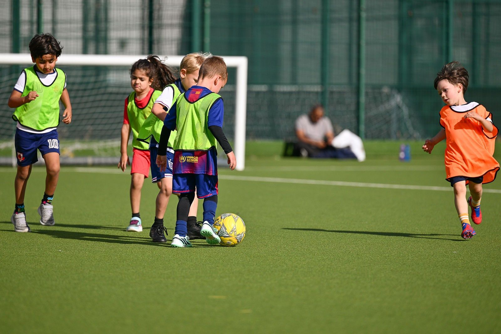 Children dribbling between cones in an FC Alpha academy session