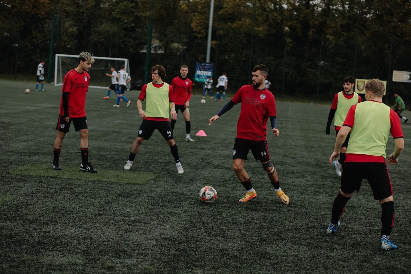 FC Alpha players pressing for the ball in a league match