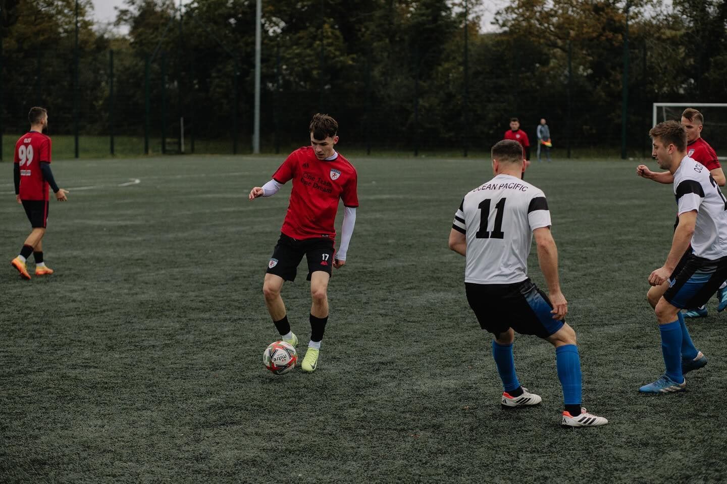 An FC Alpha player running at the defence with the ball