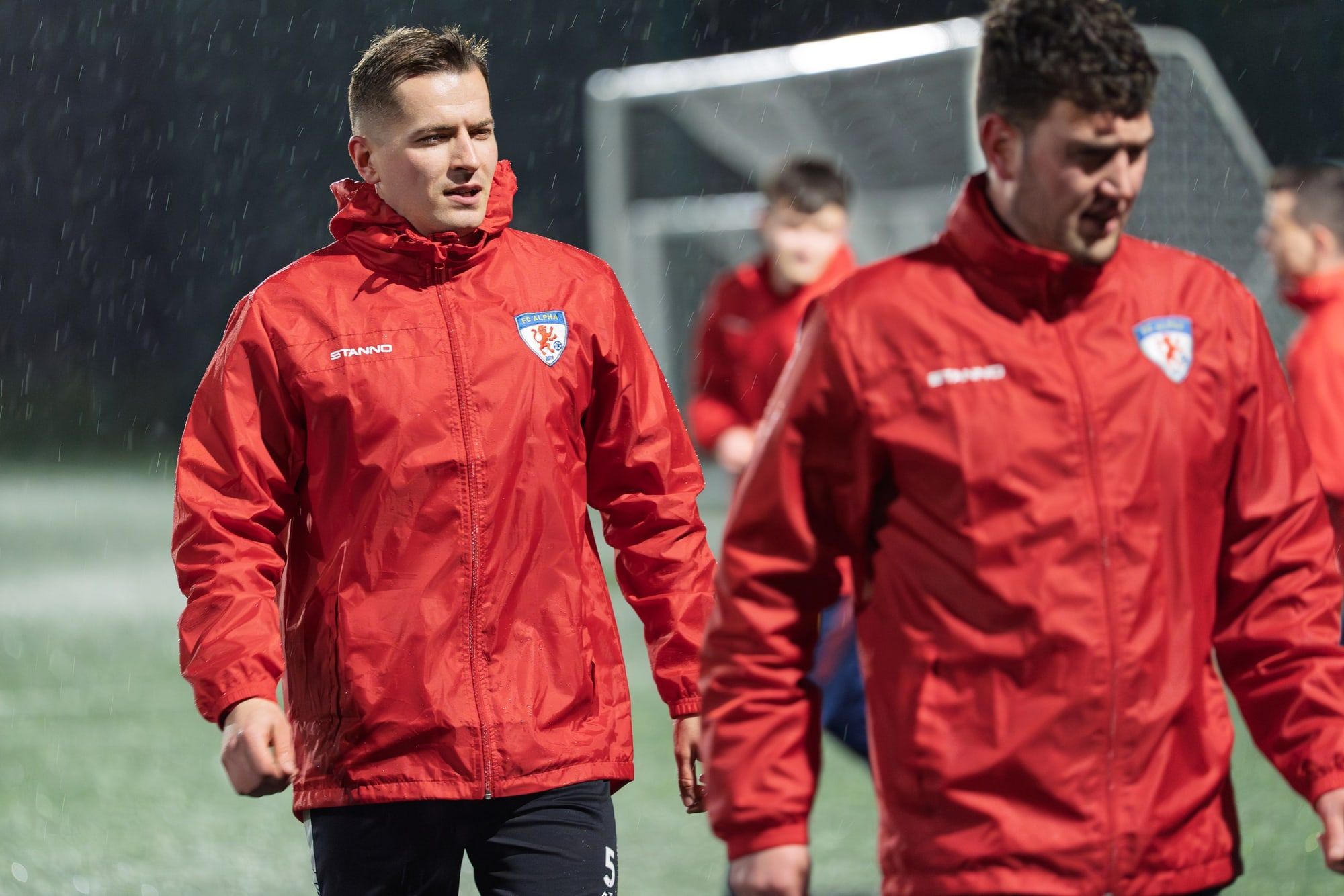 Two FC Alpha senior players jogging at training
