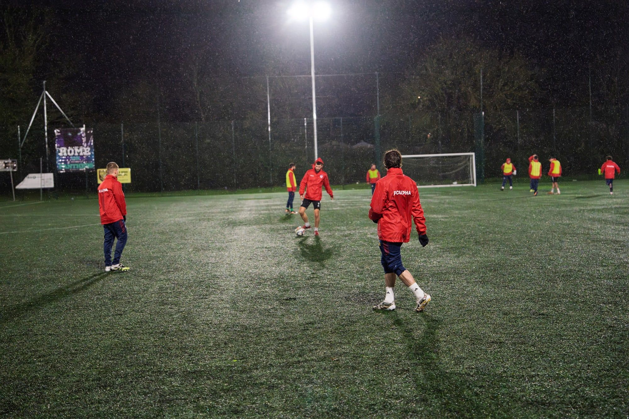 Senior players passing the ball in evening training