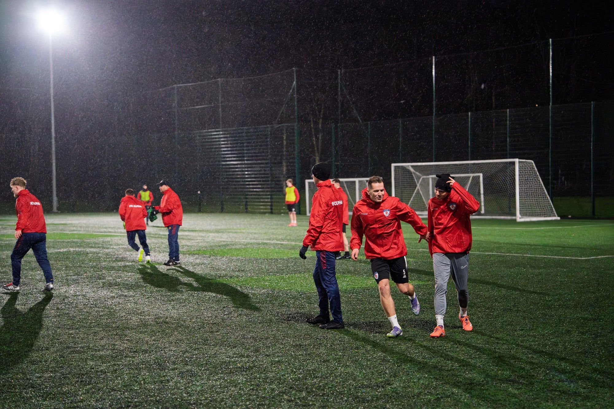 A small group of senior players in a training drill at night